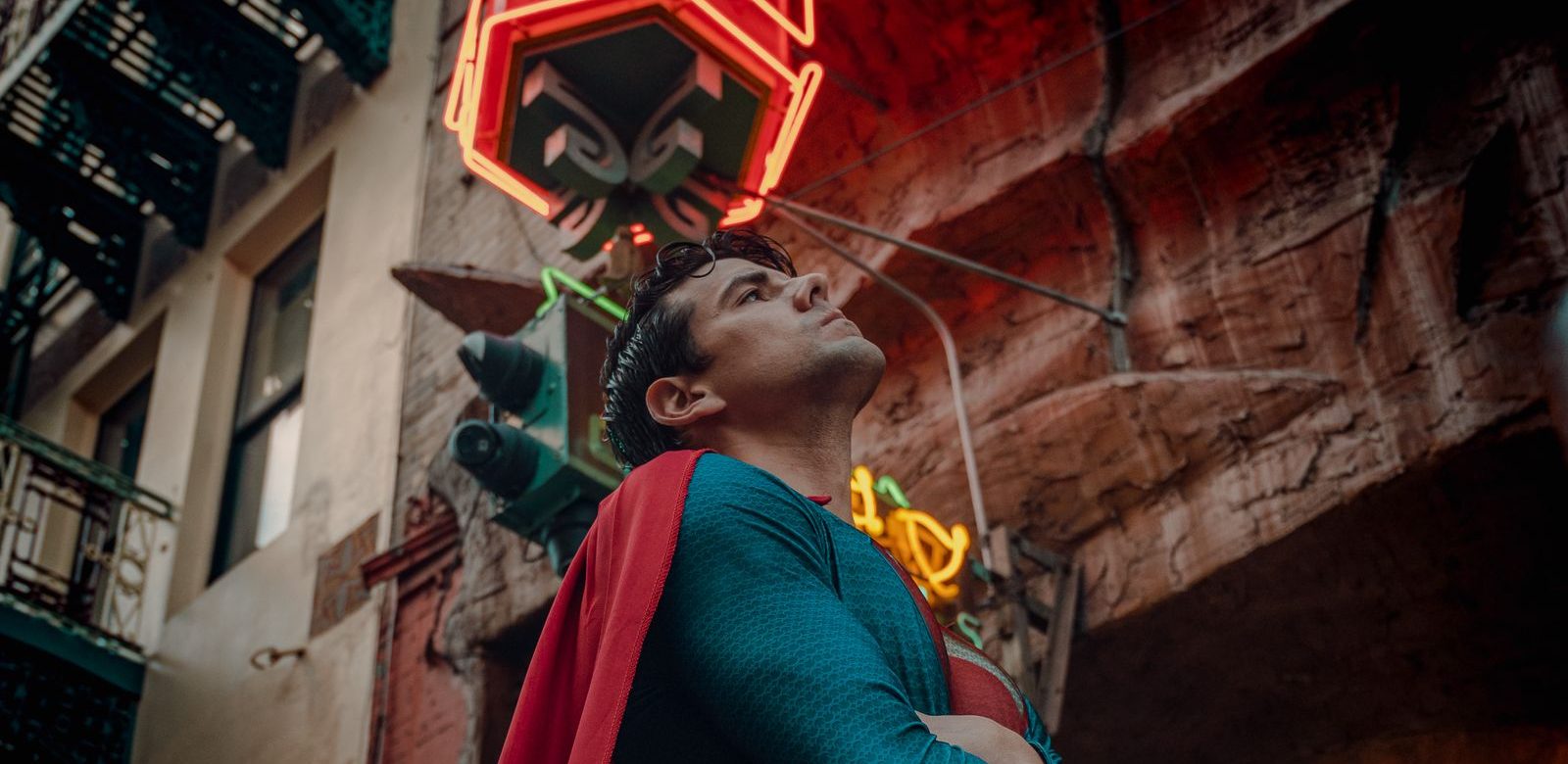 Iemand in een Superman-pak knielt op straat